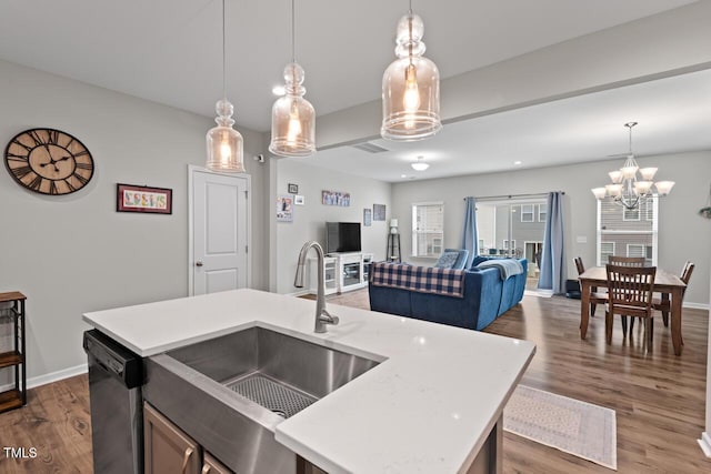 kitchen featuring light countertops, dishwasher, and a sink