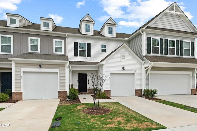 townhome / multi-family property with an attached garage, roof with shingles, and brick siding