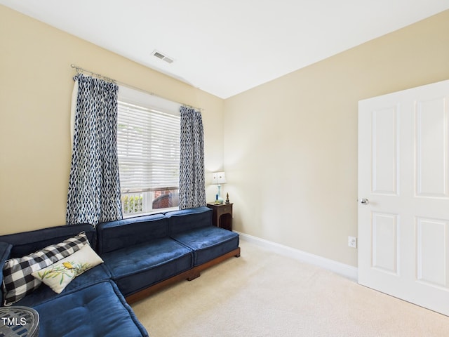 living area featuring visible vents, carpet flooring, and baseboards