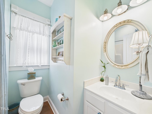 full bath featuring baseboards, wood finished floors, vanity, and toilet