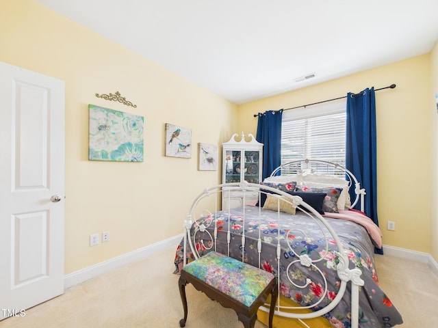 carpeted bedroom with visible vents and baseboards