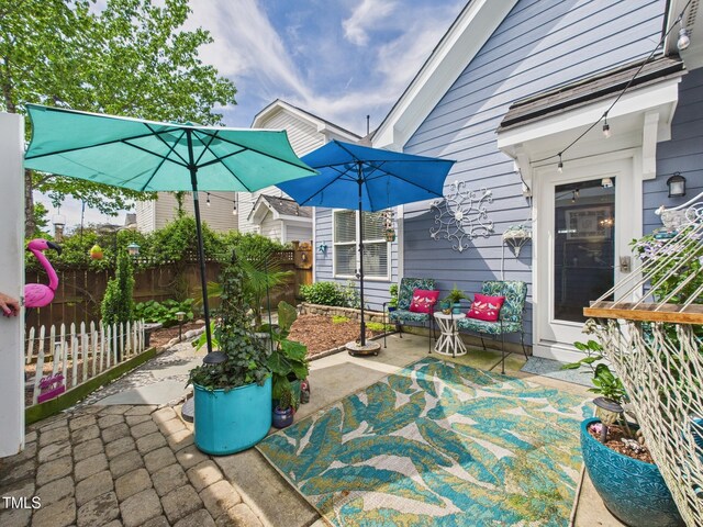 view of patio with fence and outdoor lounge area