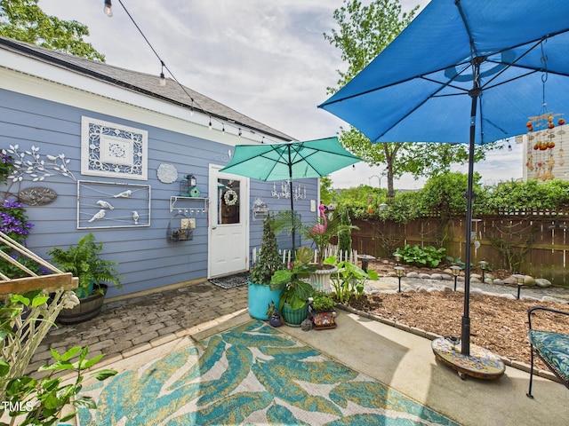 view of patio / terrace featuring fence