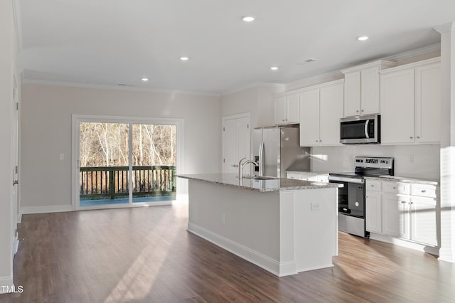 kitchen with a center island with sink, light stone countertops, ornamental molding, and stainless steel appliances