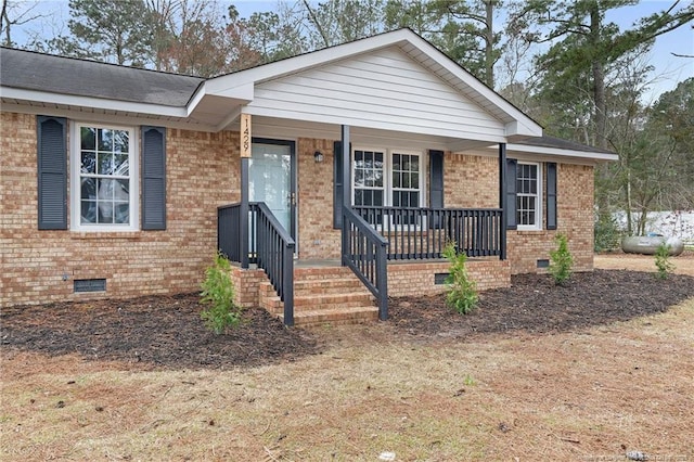 1429 Pocosin Rd, Winterville, NC 28590 - view of front facade featuring brick siding, crawl space, and a porch