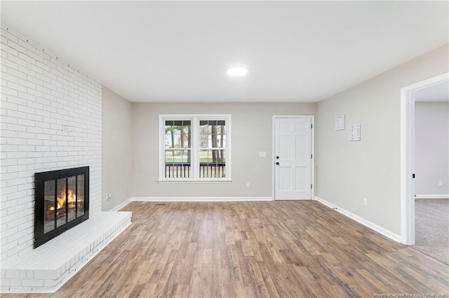 1429 Pocosin Rd, Winterville, NC 28590 - unfurnished living room with baseboards, a fireplace, and wood finished floors