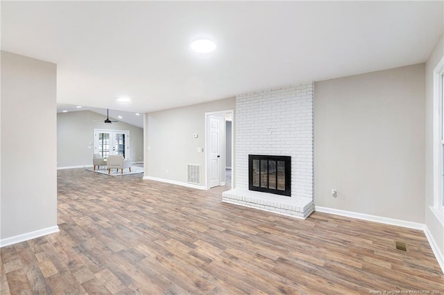 1429 Pocosin Rd, Winterville, NC 28590 - unfurnished living room with baseboards, visible vents, wood finished floors, and a fireplace
