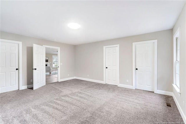 1429 Pocosin Rd, Winterville, NC 28590 - unfurnished bedroom with baseboards, visible vents, two closets, and carpet