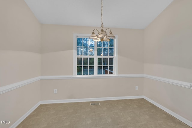 unfurnished dining area featuring baseboards, visible vents, and a notable chandelier