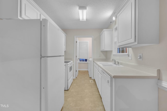 kitchen featuring a textured ceiling, light countertops, white appliances, white cabinetry, and a sink