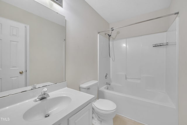 bathroom with toilet, vanity, tub / shower combination, and a textured ceiling