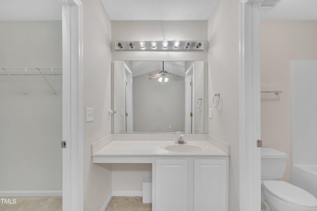 bathroom with toilet, a washtub, vanity, visible vents, and ceiling fan