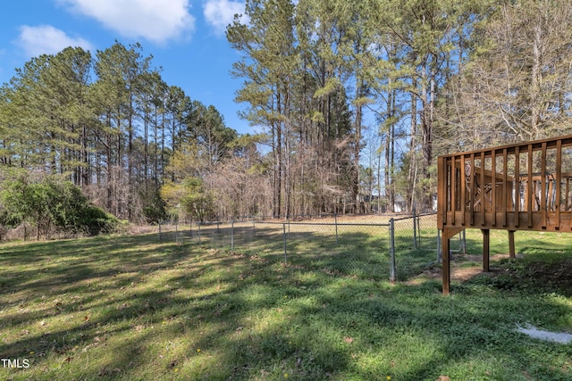 view of yard with a deck and fence