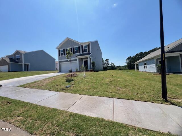 837 Kenyon Spring Dr, Zebulon, NC 27597 - traditional-style house with a garage, driveway, and a front lawn