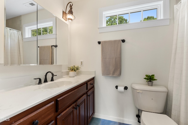 5237 Christian Light Rd, Fuquay Varina, NC 27526 - bathroom featuring plenty of natural light, toilet, vanity, and baseboards