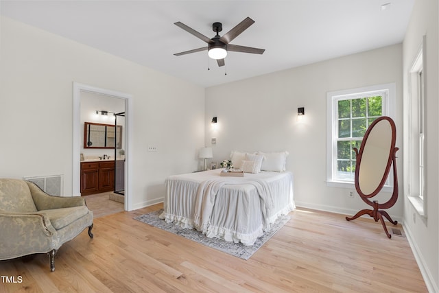 5237 Christian Light Rd, Fuquay Varina, NC 27526 - bedroom featuring light wood-style floors, connected bathroom, and baseboards