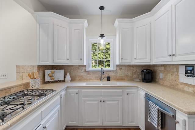 5237 Christian Light Rd, Fuquay Varina, NC 27526 - kitchen featuring a sink, appliances with stainless steel finishes, white cabinetry, and decorative backsplash