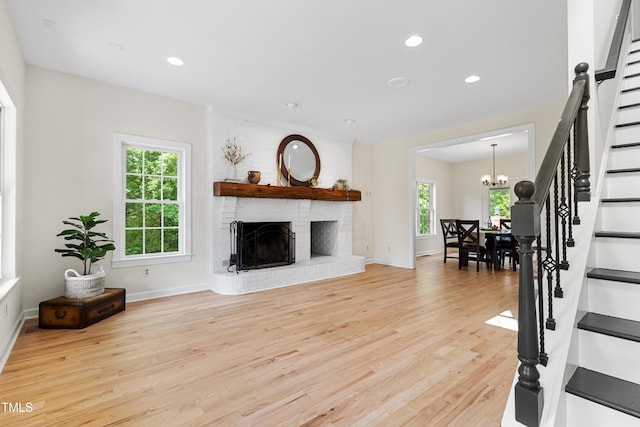 5237 Christian Light Rd, Fuquay Varina, NC 27526 - living area with stairs, healthy amount of natural light, light wood finished floors, a chandelier, and recessed lighting
