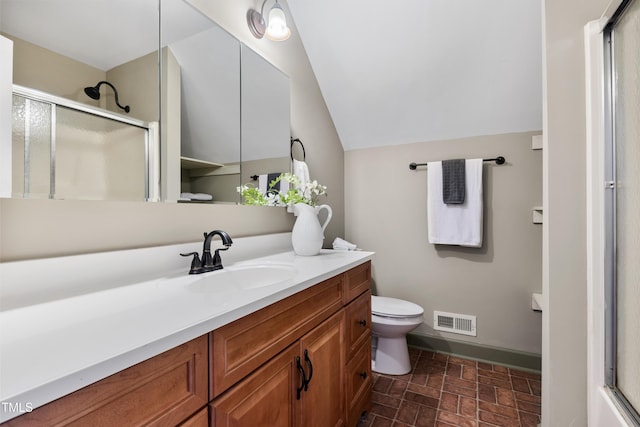 5237 Christian Light Rd, Fuquay Varina, NC 27526 - bathroom featuring a shower with shower door, toilet, vanity, vaulted ceiling, and brick patterned flooring