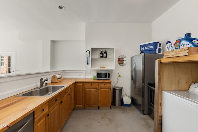 5237 Christian Light Rd, Fuquay Varina, NC 27526 - kitchen featuring washer / dryer, appliances with stainless steel finishes, finished concrete flooring, a sink, and open shelves