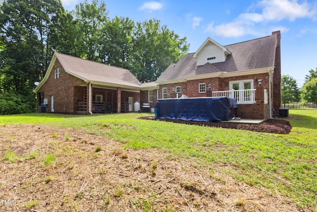 5237 Christian Light Rd, Fuquay Varina, NC 27526 - back of house featuring brick siding, a yard, a pool, and cooling unit