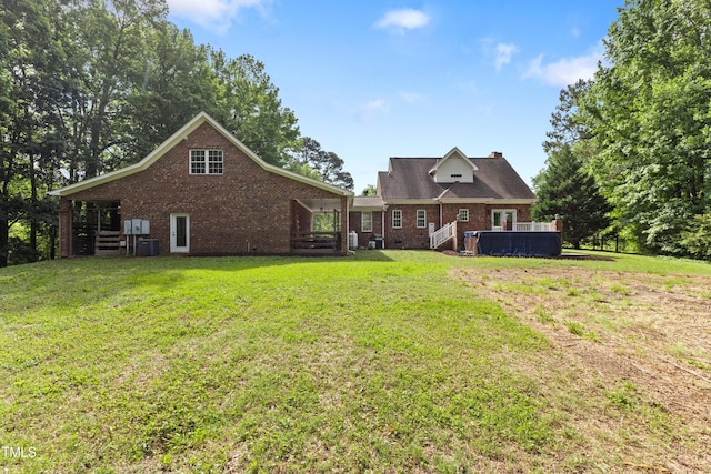 5237 Christian Light Rd, Fuquay Varina, NC 27526 - back of house featuring brick siding, a lawn, a chimney, and cooling unit
