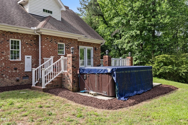 5237 Christian Light Rd, Fuquay Varina, NC 27526 - rear view of property with a jacuzzi, roof with shingles, brick siding, and a lawn