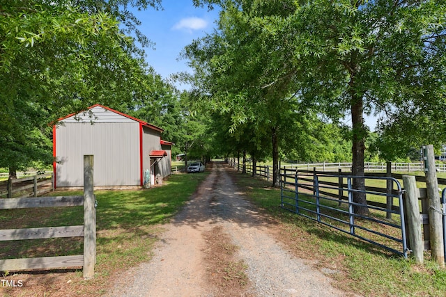 5237 Christian Light Rd, Fuquay Varina, NC 27526 - view of dirt / gravel road featuring a gated entry and a pole building