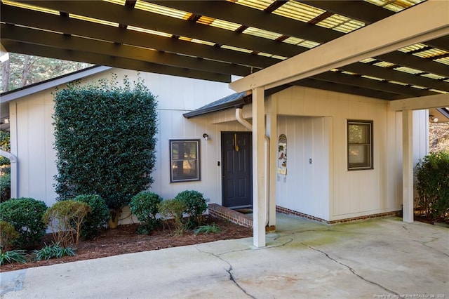 2427 Colgate Dr, Fayetteville, NC 28304 - view of exterior entry with board and batten siding and a patio