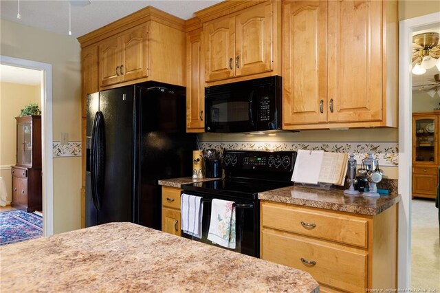 2427 Colgate Dr, Fayetteville, NC 28304 - kitchen with black appliances and a ceiling fan