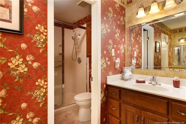 2427 Colgate Dr, Fayetteville, NC 28304 - bathroom with toilet, vanity, a shower stall, a textured ceiling, and wallpapered walls