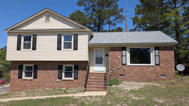 split level home with entry steps, roof with shingles, crawl space, and brick siding