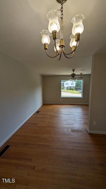 5240 Chesapeake Rd, Fayetteville, NC 28311 - unfurnished dining area featuring a chandelier, wood finished floors, and baseboards