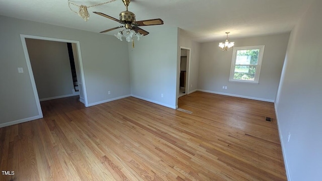 5240 Chesapeake Rd, Fayetteville, NC 28311 - unfurnished room with a chandelier, light wood-style floors, ceiling fan, and baseboards