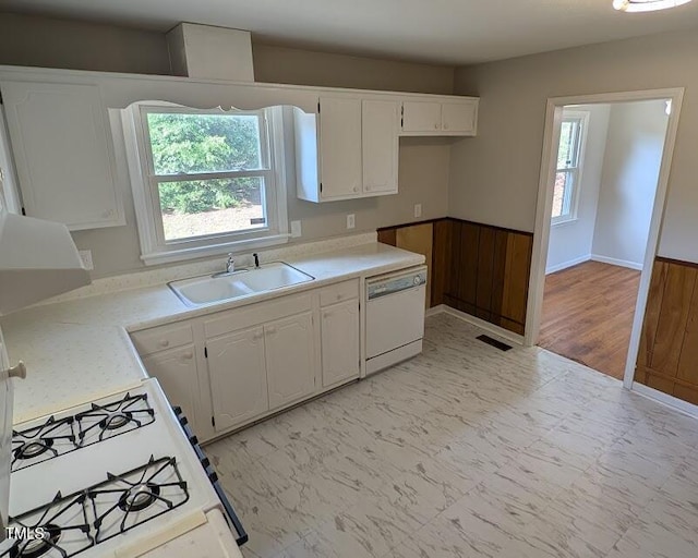 5240 Chesapeake Rd, Fayetteville, NC 28311 - kitchen featuring a sink, white appliances, white cabinets, light countertops, and a wainscoted wall