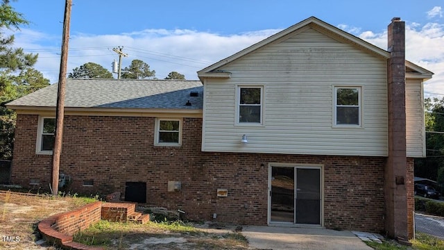 5240 Chesapeake Rd, Fayetteville, NC 28311 - back of house featuring a chimney, brick siding, and a shingled roof