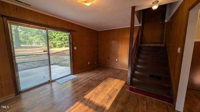 5240 Chesapeake Rd, Fayetteville, NC 28311 - spare room featuring wood finished floors, stairway, ornamental molding, wood walls, and baseboards