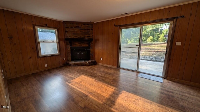 5240 Chesapeake Rd, Fayetteville, NC 28311 - unfurnished living room with plenty of natural light, wood walls, wood finished floors, crown molding, and a fireplace