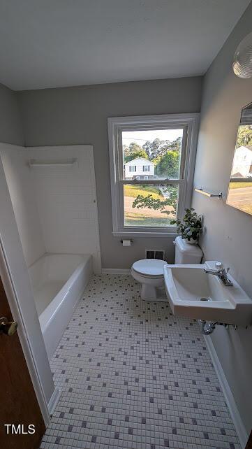 5240 Chesapeake Rd, Fayetteville, NC 28311 - full bathroom with a sink, toilet, a tub to relax in, baseboards, and a shower