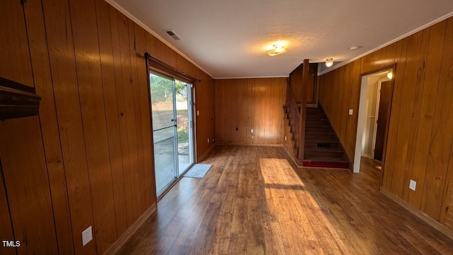 5240 Chesapeake Rd, Fayetteville, NC 28311 - unfurnished living room with wood finished floors, stairs, crown molding, wooden walls, and baseboards