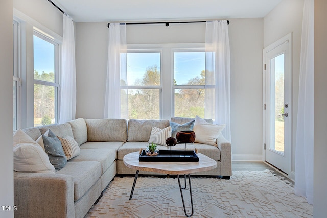 living area featuring light wood-type flooring and baseboards