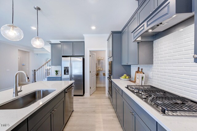 kitchen featuring crown molding, custom range hood, a sink, stainless steel appliances, and decorative backsplash