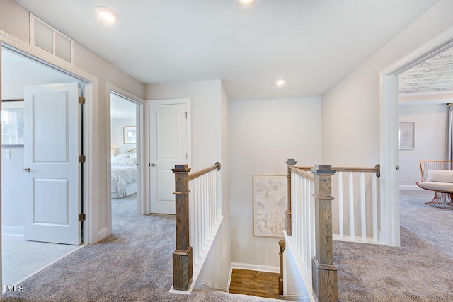 corridor with visible vents, carpet flooring, an upstairs landing, and recessed lighting