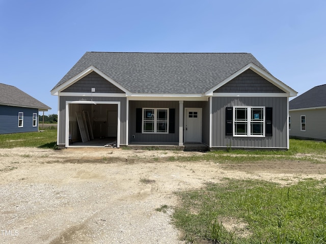 508 S Vance St, Fremont, NC 27830 - view of front of home featuring a garage, roof with shingles, and covered porch