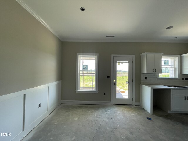 508 S Vance St, Fremont, NC 27830 - unfurnished dining area featuring unfinished concrete flooring, ornamental molding, and a sink