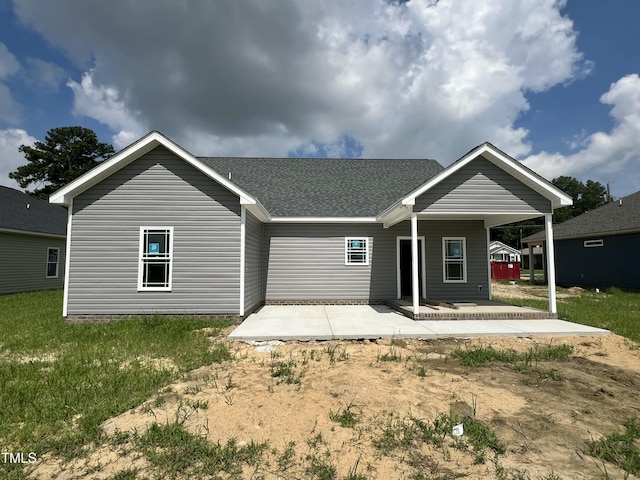 508 S Vance St, Fremont, NC 27830 - back of property featuring a patio, a shingled roof, and a lawn
