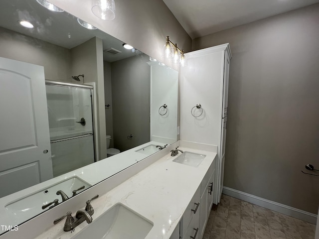 508 S Vance St, Fremont, NC 27830 - bathroom featuring a shower with door, double vanity, and marble look tile flooring