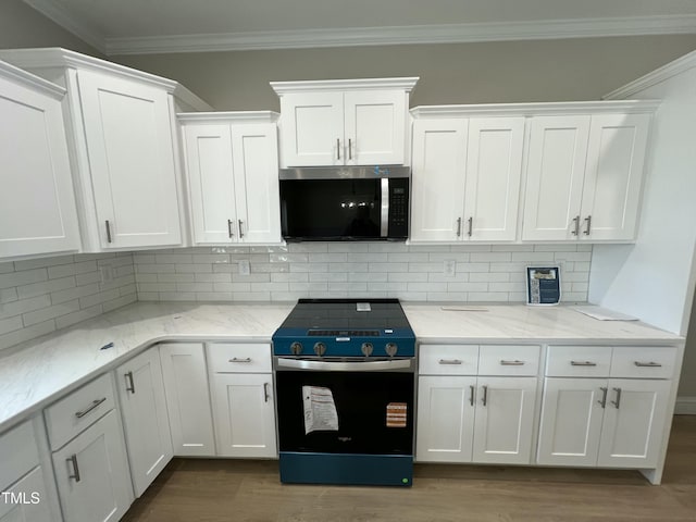 508 S Vance St, Fremont, NC 27830 - kitchen with stainless steel appliances, white cabinetry, crown molding, dark wood-type flooring, and backsplash