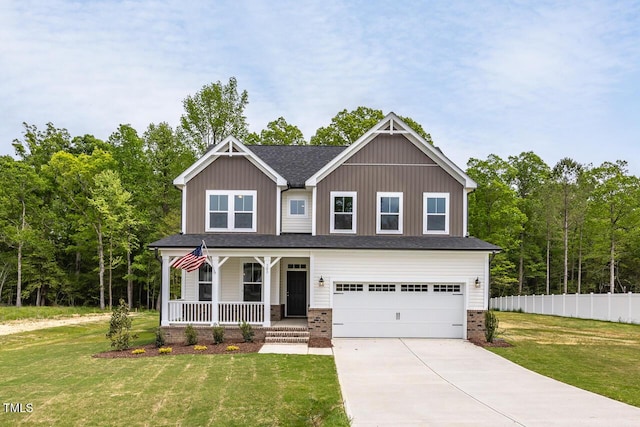 craftsman-style house with covered porch, fence, a garage, driveway, and a front lawn