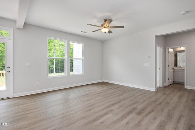 unfurnished living room featuring light wood finished floors, ceiling fan, baseboards, and visible vents